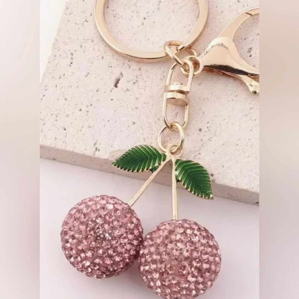 Pink Sparkling Cherry Keychain with Gold Accents and Green Leaves